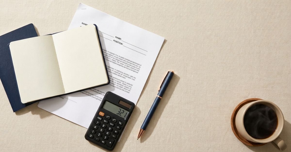 Visa sponsorship jobs salary threshold check — contract, passport and calculator on a desk